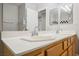 Bathroom with double sinks and a white countertop, enhanced by a large mirror reflecting the tub and shower at 9725 La Cienega St, Las Vegas, NV 89183