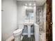 Bathroom features a single sink, toilet, and tiled shower at 9725 La Cienega St, Las Vegas, NV 89183