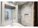 Bathroom featuring a single sink, mirror, and tiled shower at 9725 La Cienega St, Las Vegas, NV 89183