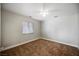 Cozy bedroom with neutral walls, carpet flooring, a ceiling fan, and a window at 9725 La Cienega St, Las Vegas, NV 89183