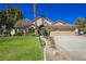 Attractive single-story house featuring a well-kept lawn and a three-car garage at 9725 La Cienega St, Las Vegas, NV 89183