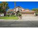 Charming single-story home with a well-manicured lawn and a three-car garage at 9725 La Cienega St, Las Vegas, NV 89183