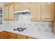 Close-up on the kitchen stovetop showing white backsplash and white countertops at 9725 La Cienega St, Las Vegas, NV 89183