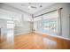 Bright living room featuring hardwood floors and large windows with natural light at 9725 La Cienega St, Las Vegas, NV 89183