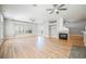 Living area with hardwood flooring, fireplace, and large windows offering bright, natural light at 9725 La Cienega St, Las Vegas, NV 89183