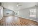 Bright living room with beautiful wood floors, recessed lighting, and multiple windows for ample natural light at 9725 La Cienega St, Las Vegas, NV 89183