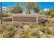 Community entrance sign for Wellington, surrounded by lush landscaping at 9725 La Cienega St, Las Vegas, NV 89183