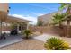 Desert landscaped backyard with a covered patio, perfect for outdoor relaxation and entertaining at 9792 Valmeyer Ave, Las Vegas, NV 89148