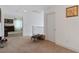 Hallway features neutral carpet and white walls with an open doorway leading into another room of the house at 9792 Valmeyer Ave, Las Vegas, NV 89148