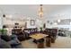 Open-concept living room and dining area featuring tile floors and stylish furnishings at 9792 Valmeyer Ave, Las Vegas, NV 89148