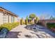 Landscaped paver backyard with a firepit, manicured greenery, and a serene outdoor setting at , Las Vegas, NV 89138