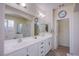 Bathroom featuring dual sinks, ample counter space, and a glass-enclosed shower at 11773 Golden Moments Ave, Las Vegas, NV 89138