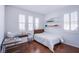 Well-lit bedroom with a study desk, shelves, and a window with plantation shutters at 11773 Golden Moments Ave, Las Vegas, NV 89138