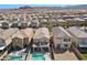 Wide aerial view showcasing modern homes with pools, spas, and desert mountain vistas at 10052 Silver Comet Ct, Las Vegas, NV 89178