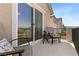 Comfortable balcony with outdoor seating, side table, and views of the surrounding area at 10052 Silver Comet Ct, Las Vegas, NV 89178