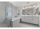 Bright bathroom with a walk-in shower, soaking tub, dual sinks, and ample vanity space at 10052 Silver Comet Ct, Las Vegas, NV 89178