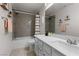 Well-lit bathroom featuring a shower-tub combo, a framed mirror, and a vanity with great counter space at 10052 Silver Comet Ct, Las Vegas, NV 89178