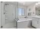 Bathroom featuring a glass-enclosed shower, soaking tub and vanity with granite countertop at 10052 Silver Comet Ct, Las Vegas, NV 89178