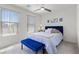 This cozy bedroom features comfortable furnishings, stylish decor, and lots of natural light from multiple windows at 10052 Silver Comet Ct, Las Vegas, NV 89178