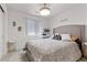 This bedroom offers a comfortable bed, a neutral palette, a ceiling fan, and stylish furniture accents at 10052 Silver Comet Ct, Las Vegas, NV 89178