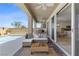Relaxing covered patio featuring comfortable seating, ceiling fans, and seamless access to the pool at 10052 Silver Comet Ct, Las Vegas, NV 89178