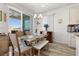 Bright dining area with a stylish table, seating, and sliding glass doors that bring the outdoors inside at 10052 Silver Comet Ct, Las Vegas, NV 89178