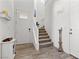 This entryway features wood-look floors, a staircase, and neutral colors, offering a bright and welcoming space at 10052 Silver Comet Ct, Las Vegas, NV 89178