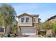 Charming two-story home featuring a stone-accented facade and an attached two-car garage at 10052 Silver Comet Ct, Las Vegas, NV 89178