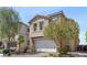 Charming two-story home featuring a two-car garage, desert landscaping, and a welcoming entrance at 10052 Silver Comet Ct, Las Vegas, NV 89178
