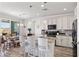 Modern kitchen featuring granite countertops, stainless steel appliances, and a breakfast bar with seating at 10052 Silver Comet Ct, Las Vegas, NV 89178