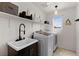 Functional laundry room with modern appliances and storage for efficient cleaning at 10052 Silver Comet Ct, Las Vegas, NV 89178