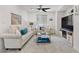 Inviting living room with plush seating, a TV, and stylish decor with carpeted flooring at 10052 Silver Comet Ct, Las Vegas, NV 89178