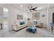 This living room features neutral-toned sofas, decorative accents, and a ceiling fan for added comfort at 10052 Silver Comet Ct, Las Vegas, NV 89178