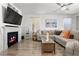 Inviting living room with fireplace, mounted TV, and neutral color scheme at 10052 Silver Comet Ct, Las Vegas, NV 89178