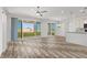 Bright, open living space with wood-style flooring and sliding glass doors to the backyard at 10052 Silver Comet Ct, Las Vegas, NV 89178