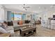 Open-concept living space featuring hardwood floors, lots of seating and tons of natural light at 10052 Silver Comet Ct, Las Vegas, NV 89178