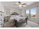 Serene main bedroom with a ceiling fan, neutral colors, and a sliding glass door to a balcony at 10052 Silver Comet Ct, Las Vegas, NV 89178