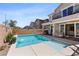 Beautiful backyard pool with water features, outdoor seating and desert landscaping at 10052 Silver Comet Ct, Las Vegas, NV 89178