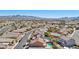 An aerial view shows the neighborhood featuring well-maintained homes and a sparkling pool at 1033 Via Dell Bacio Dr, Henderson, NV 89052