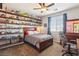 Comfortable bedroom featuring decorative shelves, a ceiling fan, and neutral walls at 1033 Via Dell Bacio Dr, Henderson, NV 89052