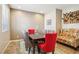 Dining room with modern table, colorful chairs, and unique wine storage at 1033 Via Dell Bacio Dr, Henderson, NV 89052