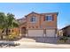 Charming two-story home boasts a three-car garage and desert landscaping at 1033 Via Dell Bacio Dr, Henderson, NV 89052