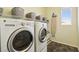 Practical laundry room with modern washer and dryer units and functional storage at 1033 Via Dell Bacio Dr, Henderson, NV 89052