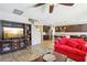 Spacious living room with a cozy red couch and an open view to the modern kitchen at 1033 Via Dell Bacio Dr, Henderson, NV 89052