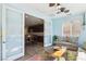 Open living room adjacent to kitchen boasts tile floors and a ceiling fan for added comfort at 1033 Via Dell Bacio Dr, Henderson, NV 89052