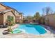 Inviting backyard pool with a built-in spa, tanning ledge, and lush landscaping at 1033 Via Dell Bacio Dr, Henderson, NV 89052