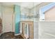 Modern walk-in shower featuring mosaic tile accents and a window for natural light at 1033 Via Dell Bacio Dr, Henderson, NV 89052