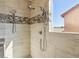 Shower with dual showerheads and pebble accent tiles at 1033 Via Dell Bacio Dr, Henderson, NV 89052