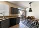 Bright kitchen and breakfast nook featuring stylish gray cabinets, granite countertops, stainless appliances, and backyard access at 1056 Sweeping Ivy Ct, Las Vegas, NV 89183