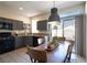 Open kitchen with gray cabinets, a breakfast nook with large windows, and sliding door access to the outdoor patio at 1056 Sweeping Ivy Ct, Las Vegas, NV 89183